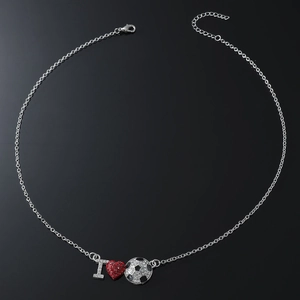 Sparkling I Love Soccer necklace with crystal heart and football pendant on black surface