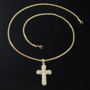 Hip hop iced out gold cross pendant necklace with white zircon and rope chain on black surface