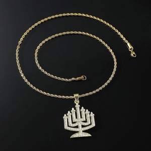 Hip hop iced out menorah pendant necklace with gold twist rope chain on black background