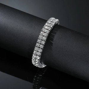Detailed view of silver double-row rhinestone bracelet on black display stand