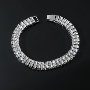 Close-up of dual-row rhinestone tennis bracelet with silver finish on a black mirror