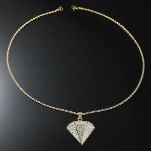 Close-up of hip hop gold rope chain with a crystal-encrusted triangle diamond pendant
