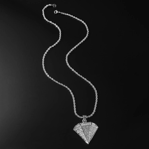 Close-up of hip-hop silver rope chain with iced-out triangle diamond pendant on black background