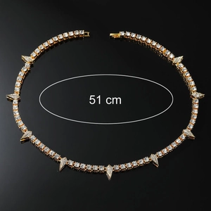 Detail shot of a 51 cm gold-toned tennis chain necklace with spiked zircon accents