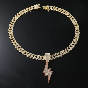 Detail of hip hop lightning pendant with pink and white rhinestones on gold cuban chain