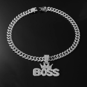 Close-up of hip-hop silver plated Cuban chain with iced out BOSS crown pendant