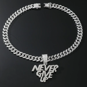 Macro view of silver Never Give Up pendant with pavé crystals on a thick Cuban chain