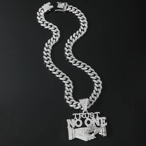 Detail of silver Cuban link chain with Trust No One iced out rhinestone pendant