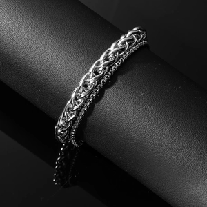 Polished silver titanium steel double-layer chain bracelet on a black display stand