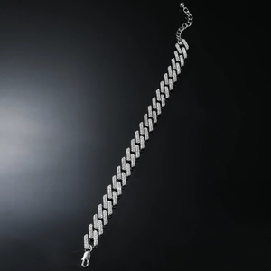 Detail of silver plated iced out Cuban link chain anklet with lobster clasp and extender