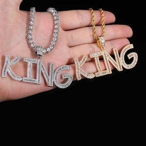 Detail of KING pendant with zircon stones on tennis and rope chains in gold and silver
