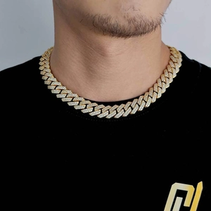 Close-up of 15mm gold Cuban link necklace with iced out zircon pavé on male model