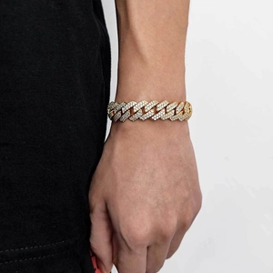 Close-up of 15mm gold Cuban link bracelet with micro-pave zircons on a male wrist