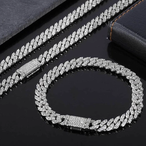 Macro detail of silver tone iced out Cuban link chain set with sparkling cubic zirconia