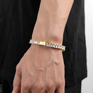 Close-up of gold plated men's tennis bracelet with rectangular zircon stones on wrist