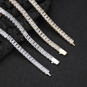 6mm gold and silver tennis bracelets with emerald cut cubic zirconia on a dark rock