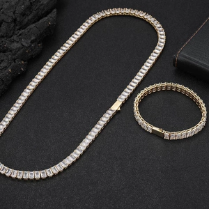 Detail shot of gold-plated tennis necklace and bracelet set with baguette-cut zircons