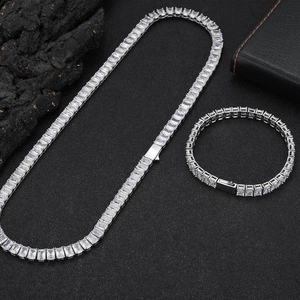 Detailed close-up of emerald-cut zircon stones on a silver-plated tennis chain bracelet