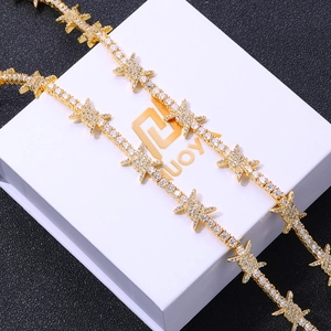 Macro shot of gold-plated thorn tennis bracelet with pavé cubic zirconia on jewelry box