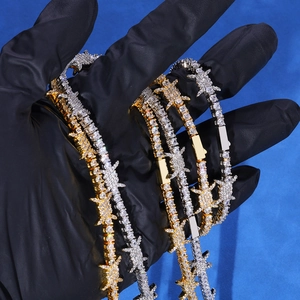 Macro detail of iced out tennis chain featuring thorn links and sparkling cubic zirconia