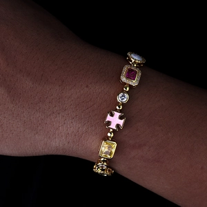 Bracciale hip hop dorato con pietre colorate, croce in smalto rosa e dettagli in zircone
