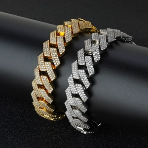 Macro detail of gold and silver Cuban link bracelets with iced-out pave set zircon