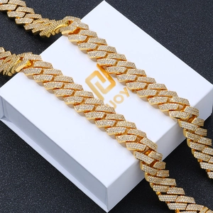 Close-up of 16mm gold-plated Cuban link chain with dense zircon stones on a jewelry box