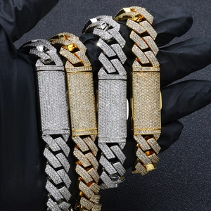 Macro view of 16mm triple-row zircon encrusted cuban link chains in gold and silver finish