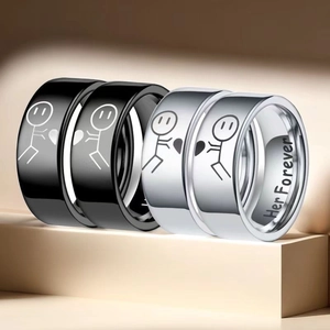 Close-up detailed view of engraved stainless steel couple rings with heart patterns