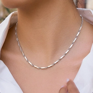 Detailed view of silver titanium steel necklace featuring twisted rectangular links and high polish