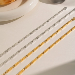 Macro shot of minimalist geometric titanium steel links in gold and silver finishes