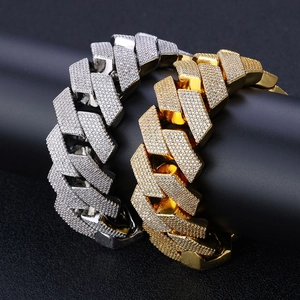 Detail of 26mm gold and silver cuban link bracelets with pavé set cubic zirconia stones