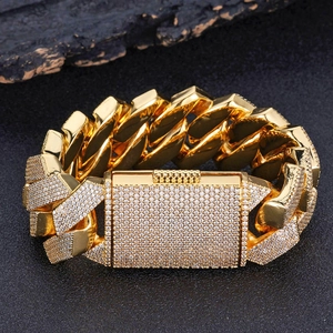 Close-up of golden 26mm Cuban chain bracelet with a large diamond-encrusted clasp