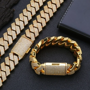 Macro view of iced out golden cuban link necklace and bracelet set with ziconia