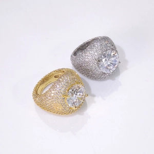 Detailed view of gold and silver hip hop rings with large center stones and full pavé
