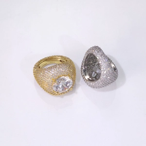 Detailed close-up of iced out hip hop rings featuring large center zircon and pave side diamonds