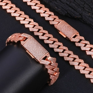 Macro detail of rose gold 15mm Cuban link chain and bracelet set with micro pavé crystals