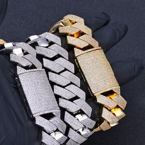 Close-up of 26mm gold and silver Cuban link bracelets with iced-out zircon pave setting