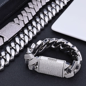 Macro view of silver Cuban link chain featuring 26mm rhinstone paving and rectangle clasp
