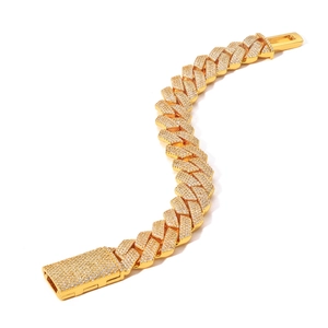 Detailed macro view of 15mm gold Cuban link bracelet with iced-out zircon pave setting