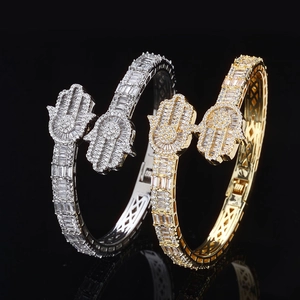 Iced out Hamsa hand cuff bracelets in silver and gold with pavé set cubic zirconia