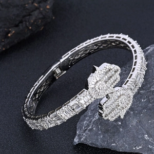 Macro view of silver Hamsa hand cuff bracelet with detailed baguette and round zircon stones