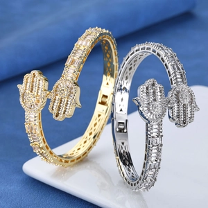Detail of Hamsa Hand bracelets in gold and silver finish with micro-pave stones