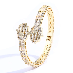 Detailed view of a gold-tone Hamsa hand cuff bracelet with sparkling crystal pavé stones