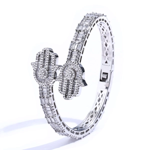 Macro detail of Hamsa Hand silver bracelet with pave-set moissanite and hollow diamond pattern
