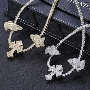 Detail of hip hop tennis chains with gold and silver cross praying hands pendants