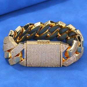 Close-up of gold iced-out Cuban link bracelet with sparkling diamond-encrusted clasp