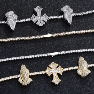 Detail of hip hop tennis chains with diamond cross and praying hands pendants