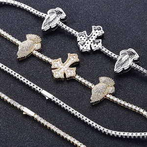 Detailed macro view of hip hop tennis chains with zircon cross and praying hand pendants