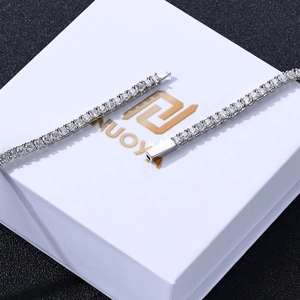 Close-up of a silver tennis bracelet with cubic zirconia on a minimalist jewelry box